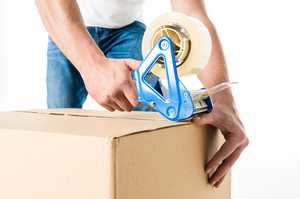CB Moving and Storage team member packing up a box