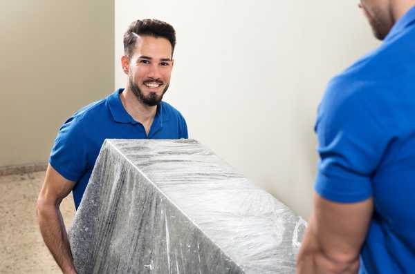 Professional mover lifting furniture into truck | CB Moving and Storage