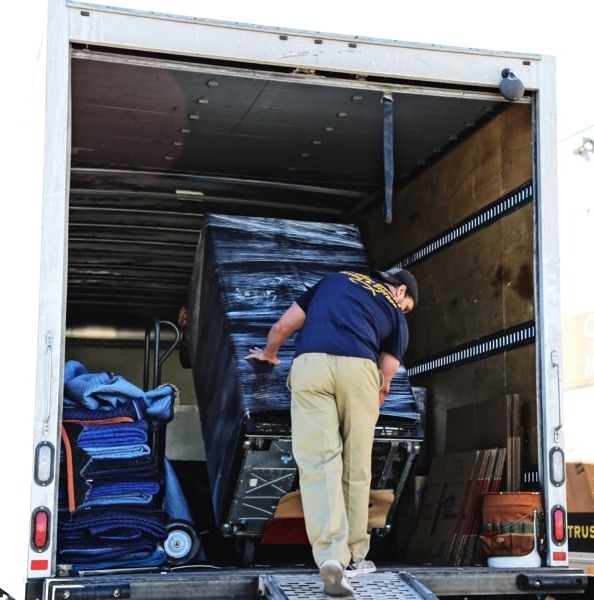 CB Moving and Storage team member, unloading heavy items from the truck